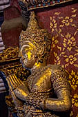 Chiang Mai - The Wat Phra Singh temple. The ubosot (ordination hall). Detail of the ku, a large ornate Buddha throne that sits in the middle of the building. 